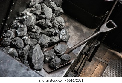 Shovel And Coal In Historic Steam Locomotive. Industrial Revolution Theme.