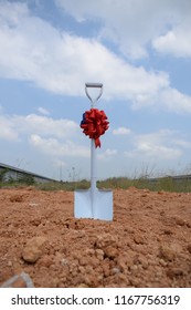 Shovel Decorate With Ribbon For Groundbreaking Ceremony With Beautiful Clear Blue Sky