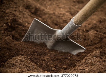 Shovel in the ground, close-up.