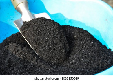 Shovel on charcoal (biochar) texture background for fertilizer. biochar powder