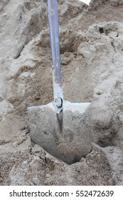 shovel in the sand - Shutterstock ID 552472639