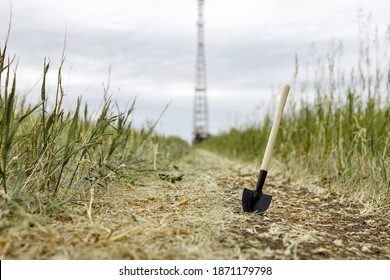 Shovel Stuck In The Ground On The Road Leading To The Cell Tower