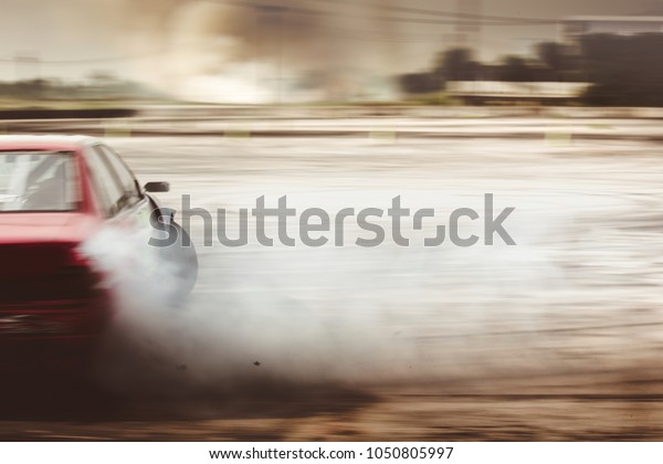 Show car drifting full of smoke. Express the speed\
of the car blur