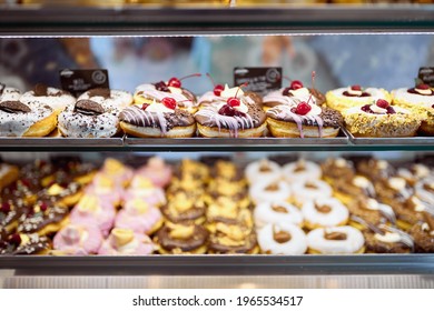 A Show Case Full Of Delicious Donuts Of Irresistible Appearance In A Candy Shop. Pastry, Dessert, Sweet