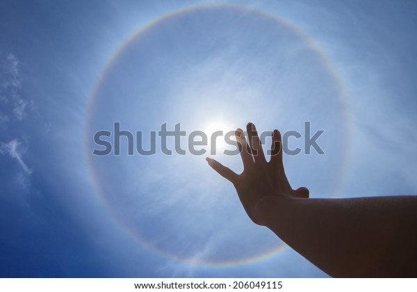 Show hand \
with Corona, ring of sun \
background