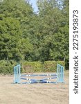 Show jumping poles obstacles, barriers, waiting for riders on show jumping training. Horse obstacle course outdoors summertime