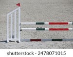 Show jumping poles obstacles, barriers, waiting for riders on show jumping training. Horse obstacle course outdoors summertime. Poles in the sand for equestrian event