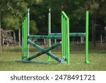 Show jumping poles obstacles, barriers, waiting for riders on show jumping training. Horse obstacle course outdoors summertime. Poles in the sand for equestrian event