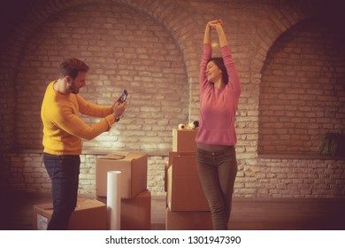 Show Me Your Happiness. Couple In The New Home. Man Taking Picture Of His Girlfriend. Copy Space.