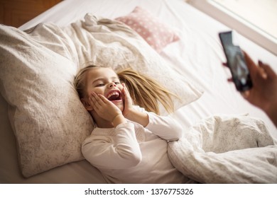 Show Me Your Smile. Mother And Daughter In Bed.