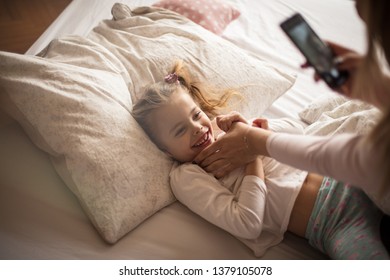 Show Me Your Smile. Mother Daughter In Bed.