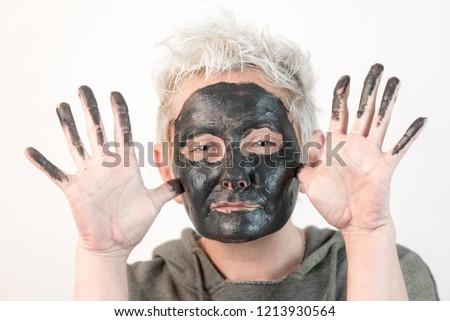 show pure emotions - face of a woman with a black mask 