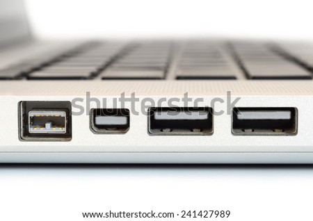 Show sideview closeup up of computer laptop selective focus on firewire port
