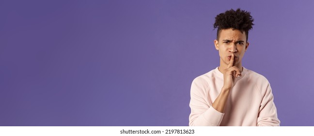 Show Some Respect. Portrait Of Angry And Annoyed, Displeased Young Hispanic Man Telling To Keep Quiet, Shushing At Someone Being Too Loud, Hold Index Finger Over Mouth Frowning, Scolding Person