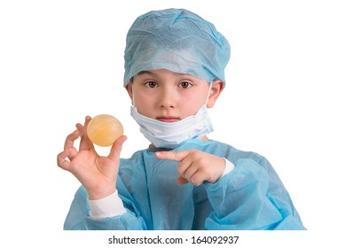 Show And Tell Third Grade Elementary Kid Looking At You And Showing His Bouncy Egg Project In His Doctor Scrubs