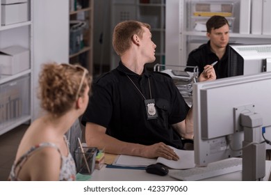 Show Of Two Policemen And A Young Woman At A Police Station