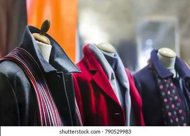 A Showcase Of Clothes Shop, Demonstrate Male And Female Coat On The Mannequin. Fashionable Brand Window. Fashion Boutique. Women's And Mens Clothing Store. Shopping Concept.