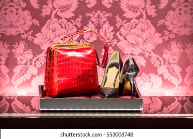 The showcase in a luxury fashion store with branded shoes and handbag