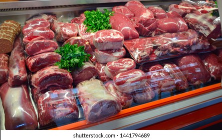 Showcase With Raw Meat In Butcher Shop