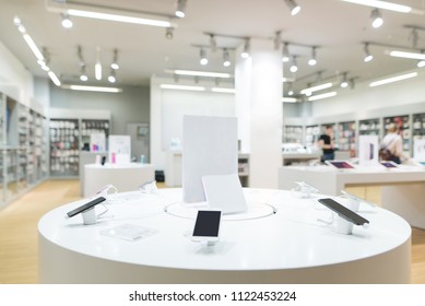 Showcase With Smartphones In The Modern Electronics Store. Buy A Mobile Phone. Many Smartphones On The Shelf Of The Technology Store.