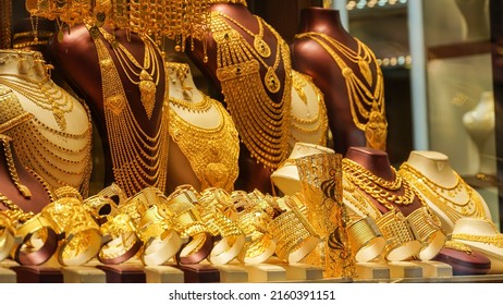 A showcase which is decorated with golden jewelleries in a shop    - Shutterstock ID 2160391151