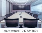 The showcases a modern, professional conference room setting.Room features a large wooden table surrounded by black mesh office chairs, indicating a space designed for meetings or collaborative work. 