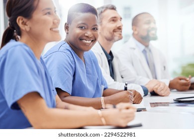 Showcasing effective multidisciplinary collaboration. Shot of a doctor sitting alongside his colleagues during a meeting in a hospital boardroom.