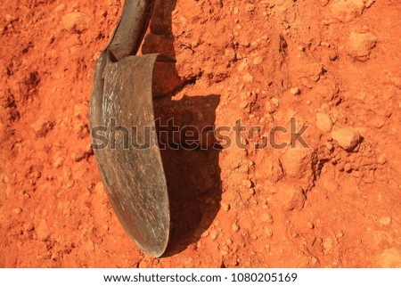 Showel and soil representing field-work.