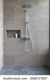 Shower at bathroom. ฺBathroom interior with shower stall and soap Gel bottle. Luxury fully tiled shower with rain head and hand held shower rose. - Shutterstock ID 2068727807