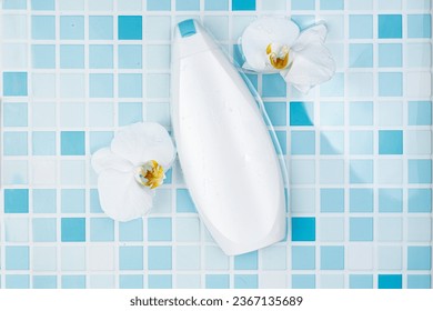 Shower gel Mockup. A bottle of shampoo lies on the blue tile in the bathroom. Anti-aging cosmetics. Orchid flowers - Shutterstock ID 2367135689