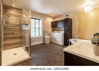 Shower With Glass, Washer, Dryer And Unpainted Wall
