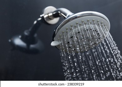 shower head in bathroom with water drops flowing - Shutterstock ID 238339219