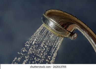 Shower Head With Water Flow Out And A Lot Of Steam Around On Copyspace.