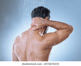 Shower, hygiene and man in studio with water splash for cleaning, grooming or shampoo on gray background. Back view, body and Asian model washing for natural treatment, wellness or morning routine - Powered by Shutterstock