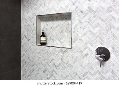 Shower Shelf Detail In Wall Of Herringbone Marble Tiles