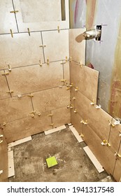 Shower Stall Wall With Grout Spacers In Preparation For New Porcelain Tile Installation