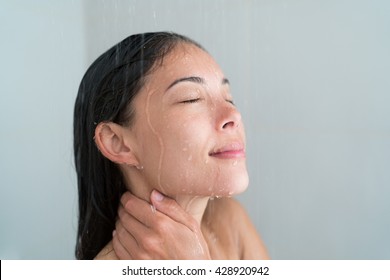 Shower Woman Showering Relaxing Under Water Massaging Neck In Hot Shower. Asian Female Adult Face Enjoying Spa Relaxation Time Relaxing Meditating In Warm Bath Cleaning Face And Body At Home.