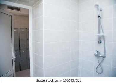 Showers In A Public Shower With Tiles And Lighting. Common Showers In The Fitness Room Or Pool