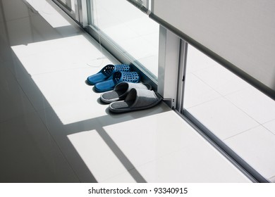 Showing The Asian Custom Of Removing Shoes Before Entering Home