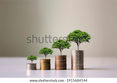 Showing financial developments and business growth with a growing tree on a coin.