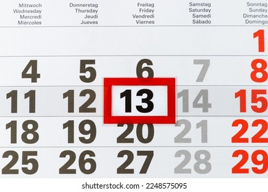 Showing friday the 13th on paper calendar. Marked date of 13 Friday.