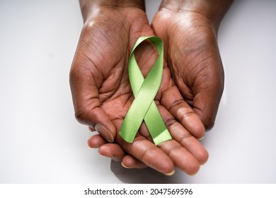 Showing Green Ribbon To Support Organ Transplant Awareness