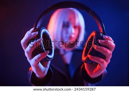 Similar – Young DJ woman in a night party