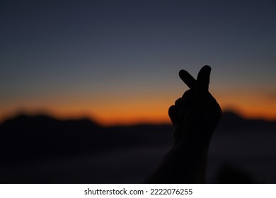 Showing Mini Heart Sign Romantic Couple In Love Gesturing Silhouette Hands Heart Sign Over Sunslight Sky Background. Show Speading Invlove And Happiness In Lifestlye