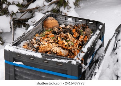 Showing open compost bin with bio waste inside, outdoors in the winter, snowy cold weather. - Powered by Shutterstock