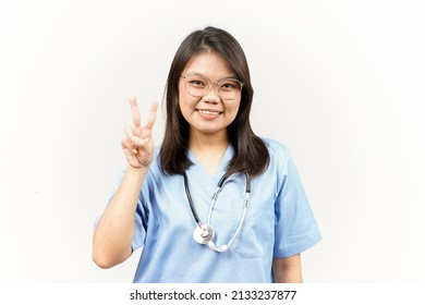 Showing Peace Sign Of Asian Young Doctor Isolated On White Background