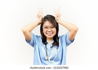 Showing Peace Sign Of Asian Young Doctor Isolated On White Background