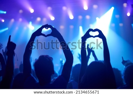 Showing their love. Shot of adoring fans at a rock concert.