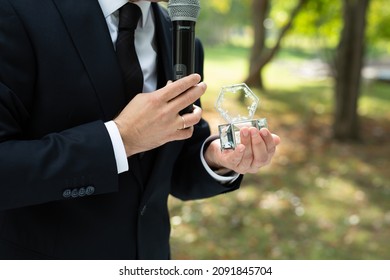 A Showman In A Classic Suit With A Microphone At A Wedding Exit Ceremony.