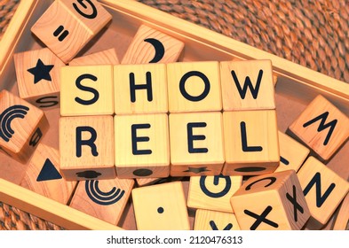 SHOWREEL Word Text From Wooden Cube Block Letters. A Showreel Also Known As A Demo Reel Or Sizzle Reel Is A Short Piece Of Edited Video Or Film Footage Showcasing A Person's Previous Work.